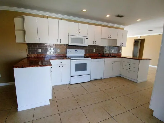 a kitchen with stainless steel appliances cabinets a sink and a counter top