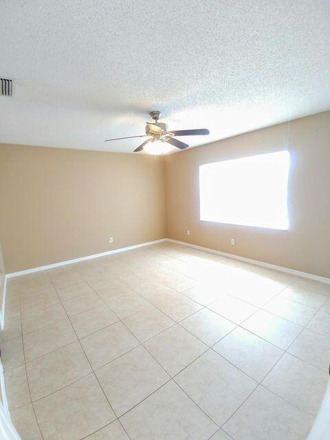 925 Southeast Albatross Avenue Port St. Lucie, FL 34983 - Photo 5 of 7 an empty room with a empty space and windows