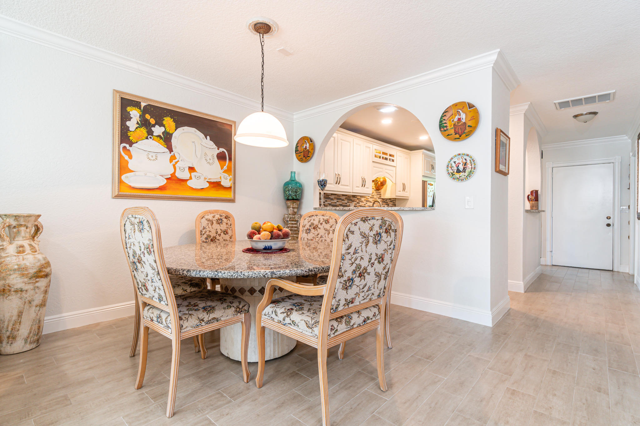 13831 Vía Flora, Unit A Delray Beach, FL 33484 - Photo 13 of 47 a view of a dining room and a table and chairs