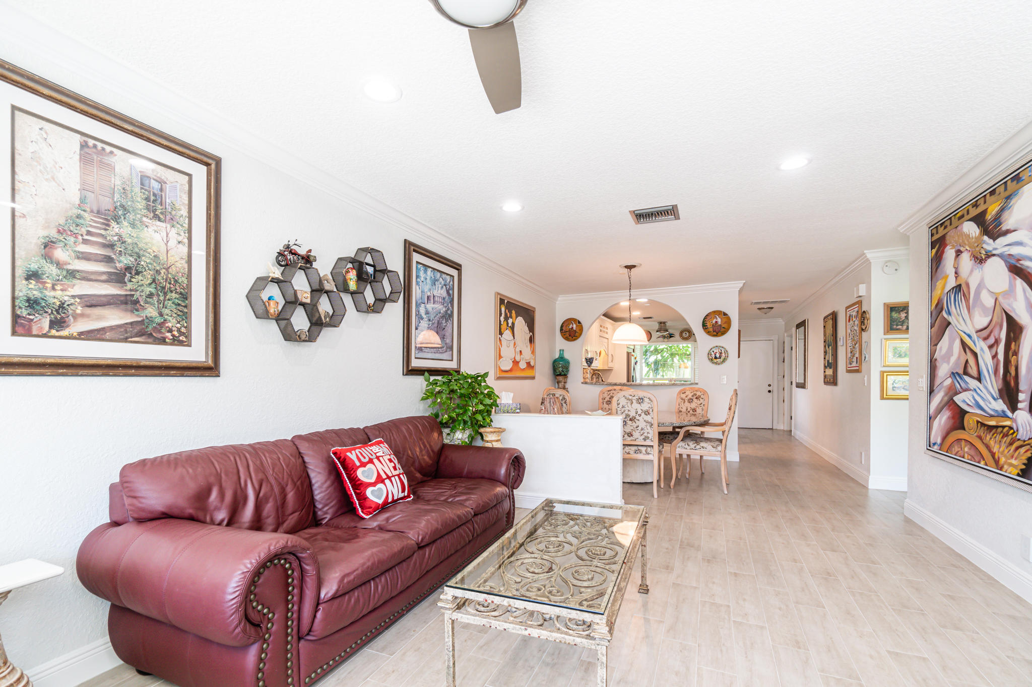 13831 Vía Flora, Unit A Delray Beach, FL 33484 - Photo 15 of 47 a living room with furniture or couch and a painting on the wall