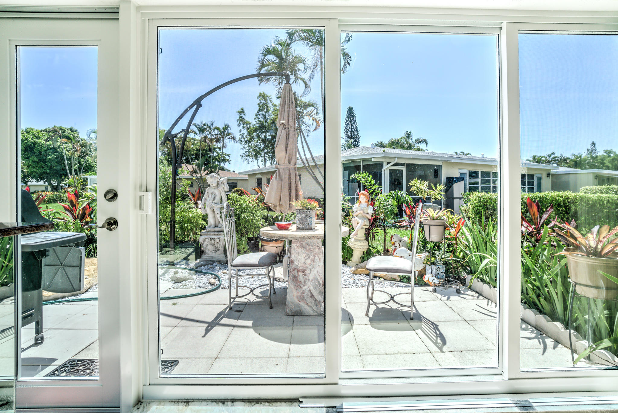 13831 Vía Flora, Unit A Delray Beach, FL 33484 - Photo 16 of 47 a view of a balcony with chairs and floor to ceiling window