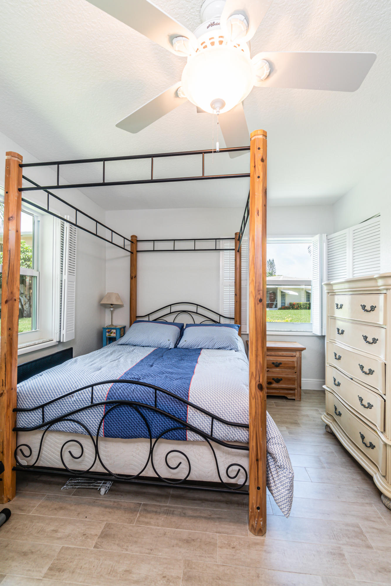 13831 Vía Flora, Unit A Delray Beach, FL 33484 - Photo 21 of 47 a bedroom with a bed and a window