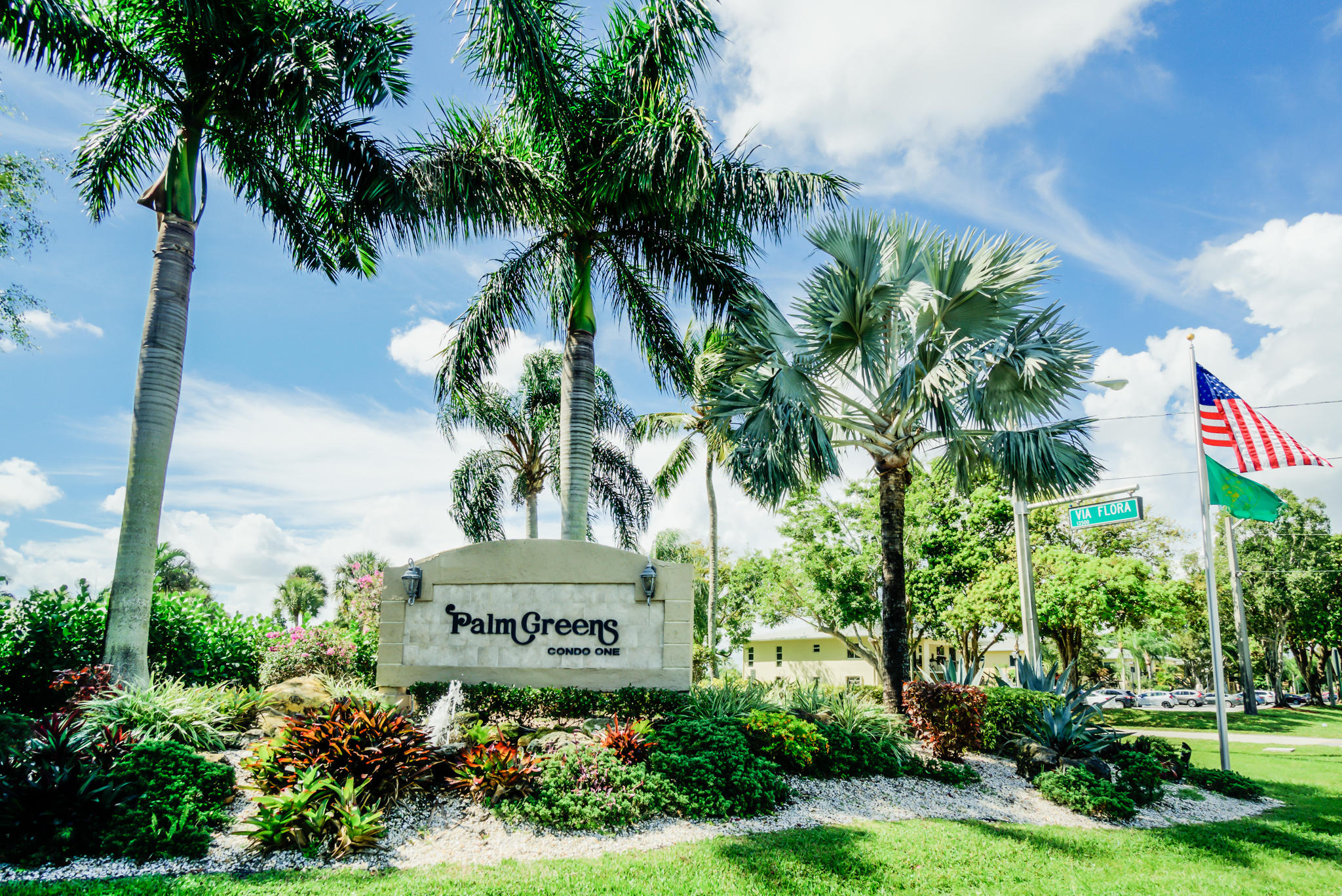 13831 Vía Flora, Unit A Delray Beach, FL 33484 - Photo 26 of 47 a sign that is sitting in front of flowers