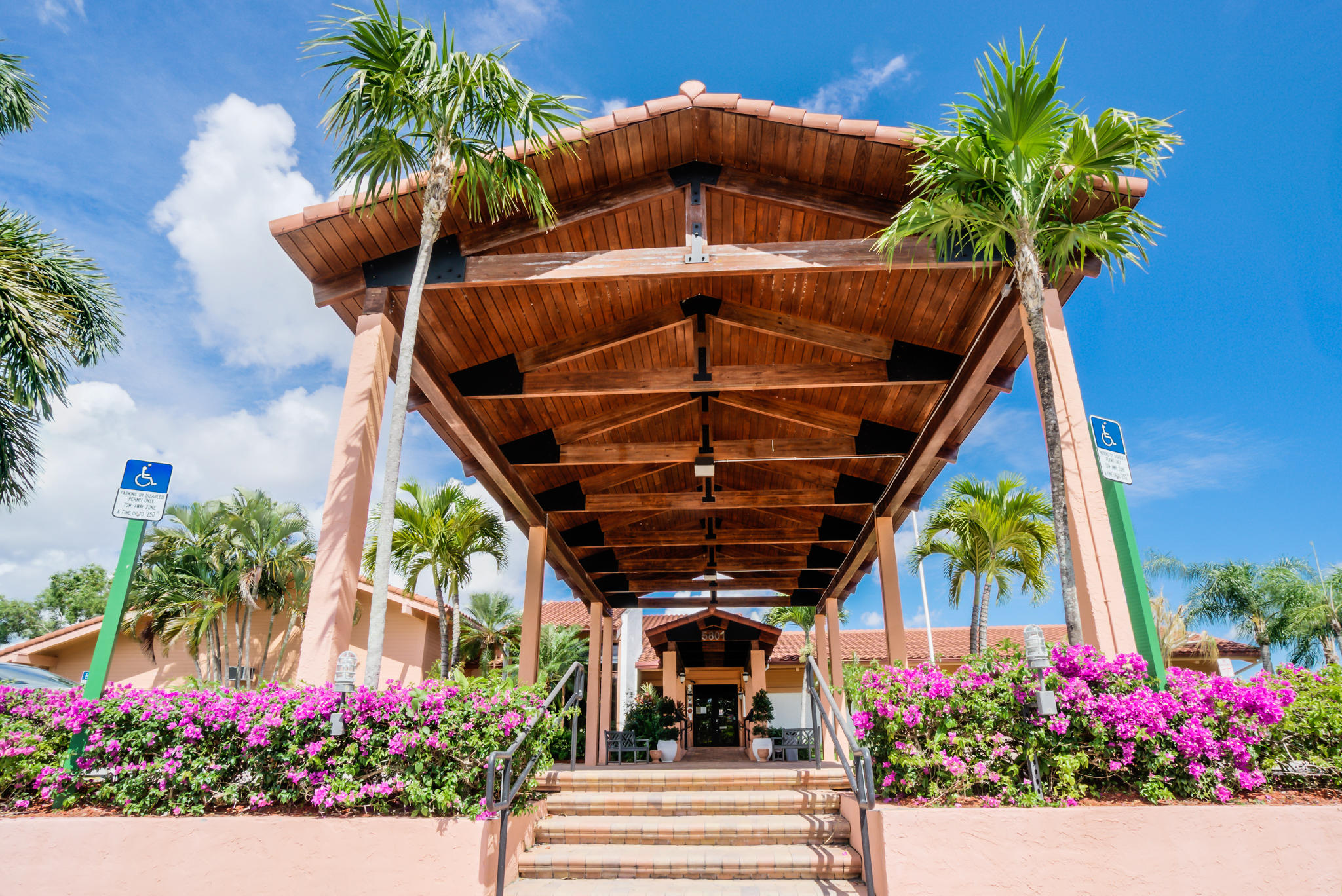 13831 Vía Flora, Unit A Delray Beach, FL 33484 - Photo 29 of 47 a view of a entryway with flower pots