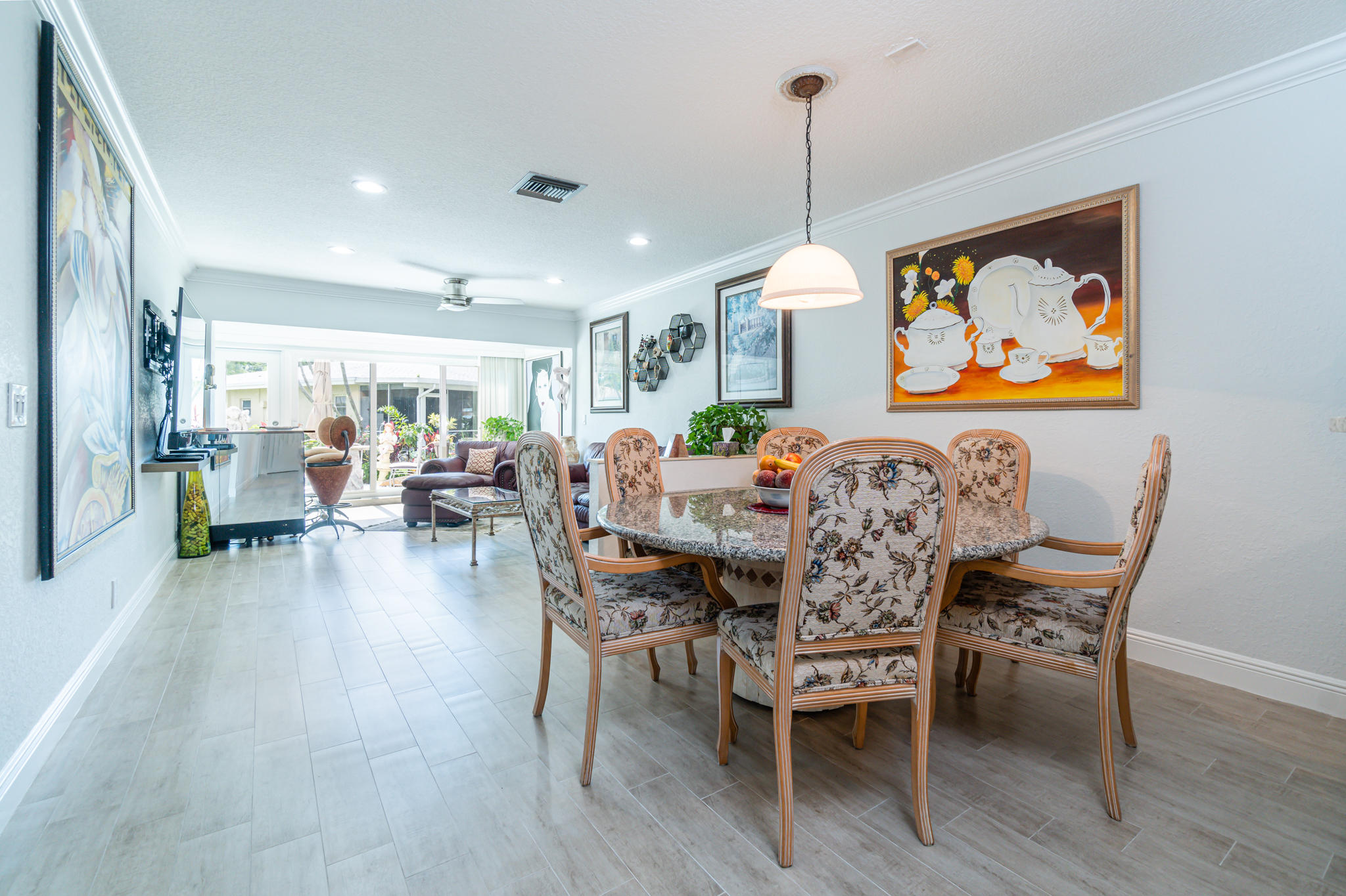 13831 Vía Flora, Unit A Delray Beach, FL 33484 - Photo 3 of 47 a dining room with furniture and wooden floor