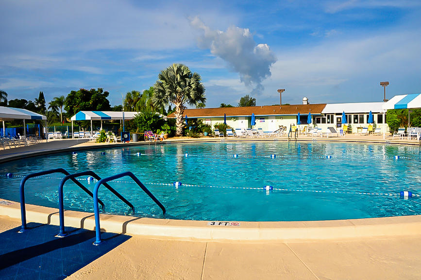 13831 Vía Flora, Unit A Delray Beach, FL 33484 - Photo 44 of 47 a view of swimming pool with outdoor seating