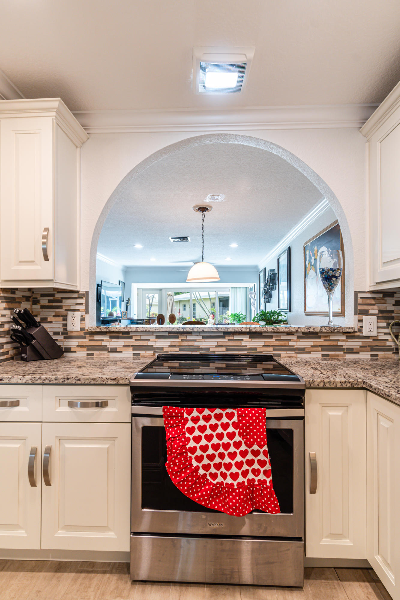 13831 Vía Flora, Unit A Delray Beach, FL 33484 - Photo 9 of 47 a kitchen with a stove window and cabinets