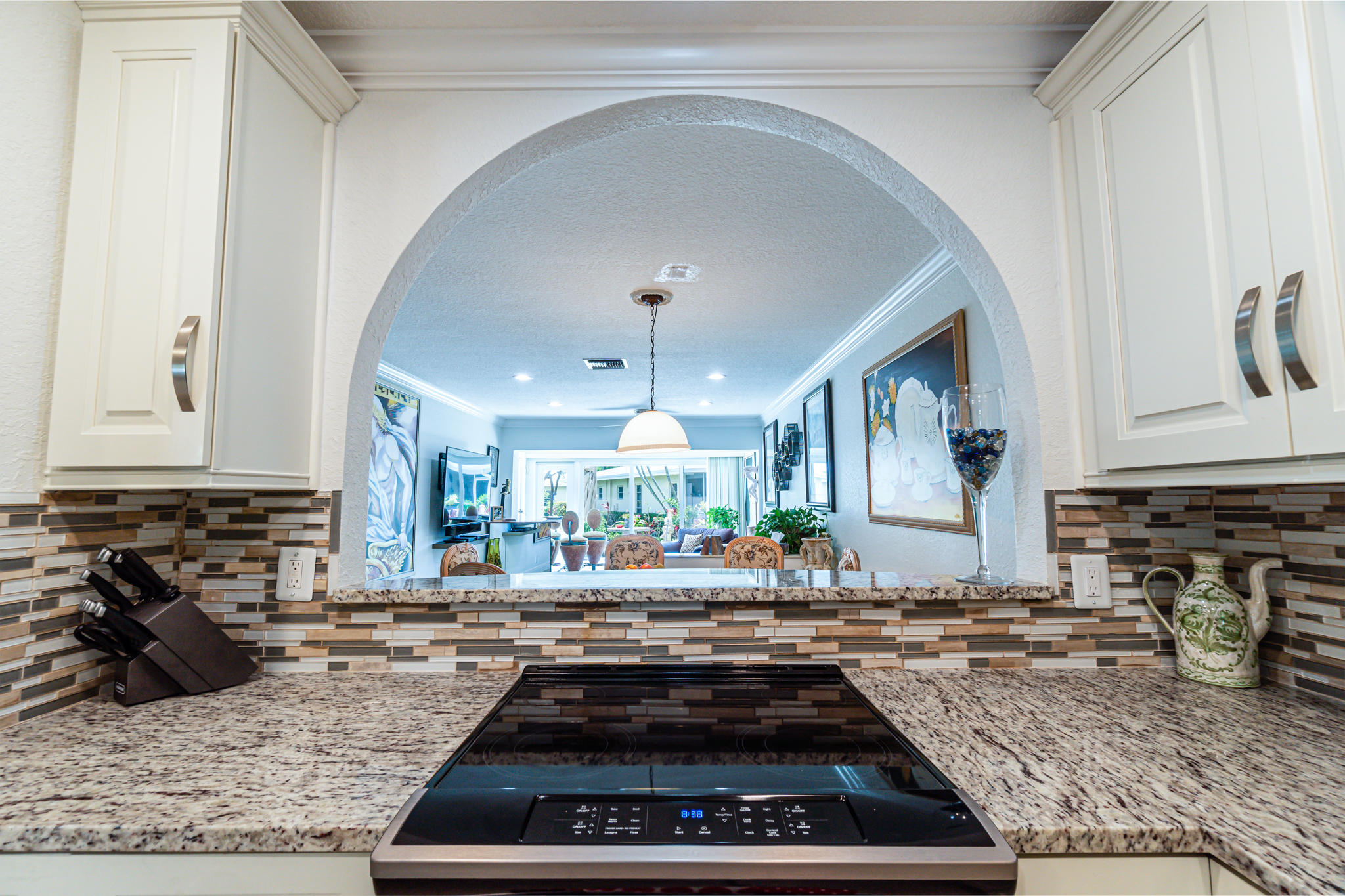 13831 Vía Flora, Unit A Delray Beach, FL 33484 - Photo 10 of 47 a kitchen with sink stove and cabinets