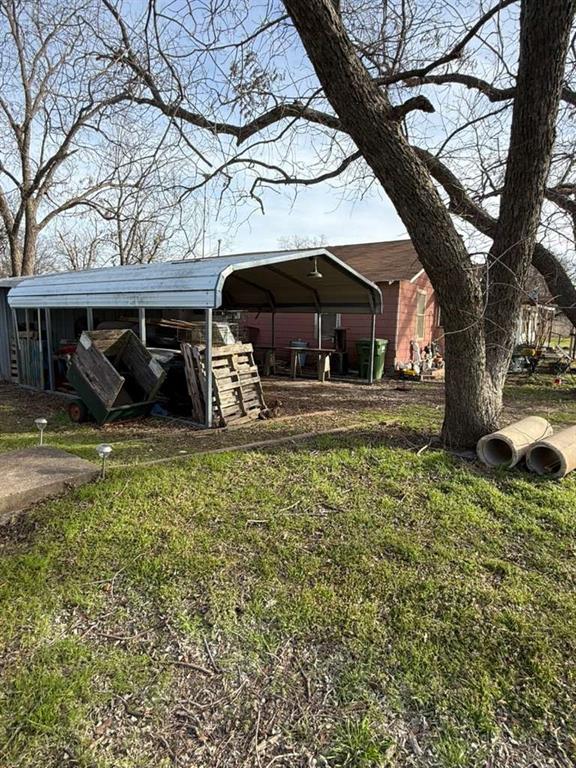 710 Whitney Street Morgan, TX 76671 - Photo 11 of 22 a view of a house with a yard