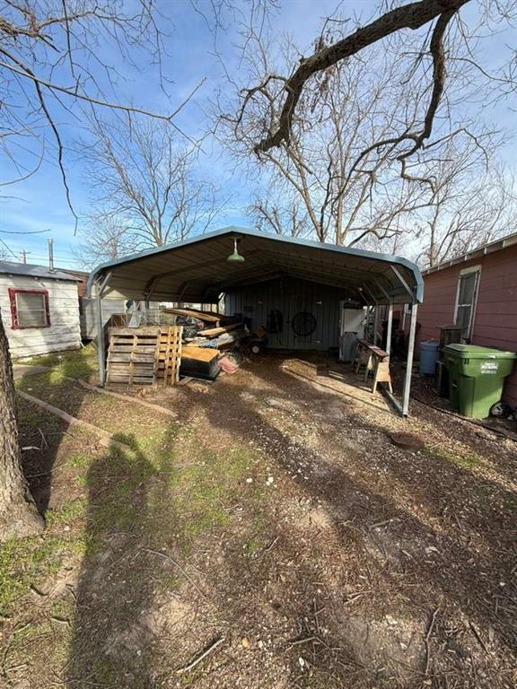 710 Whitney Street Morgan, TX 76671 - Photo 16 of 22 a view of a backyard with table and chairs under an umbrella with a small yard