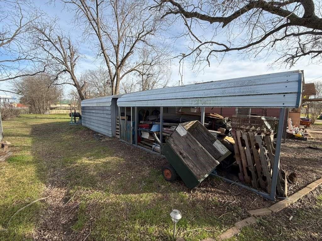 710 Whitney Street Morgan, TX 76671 - Photo 5 of 22 a view of a garage with a table and chairs