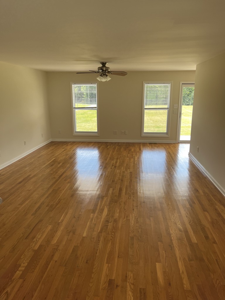 700 Old Liberty Road Alexandria, TN 37012 - Photo 4 of 12 an empty room with wooden floor and windows