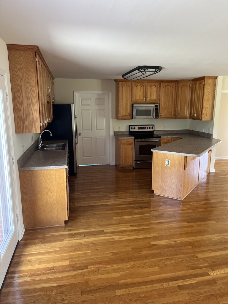 700 Old Liberty Road Alexandria, TN 37012 - Photo 6 of 12 a kitchen with granite countertop a stove a sink and a microwave