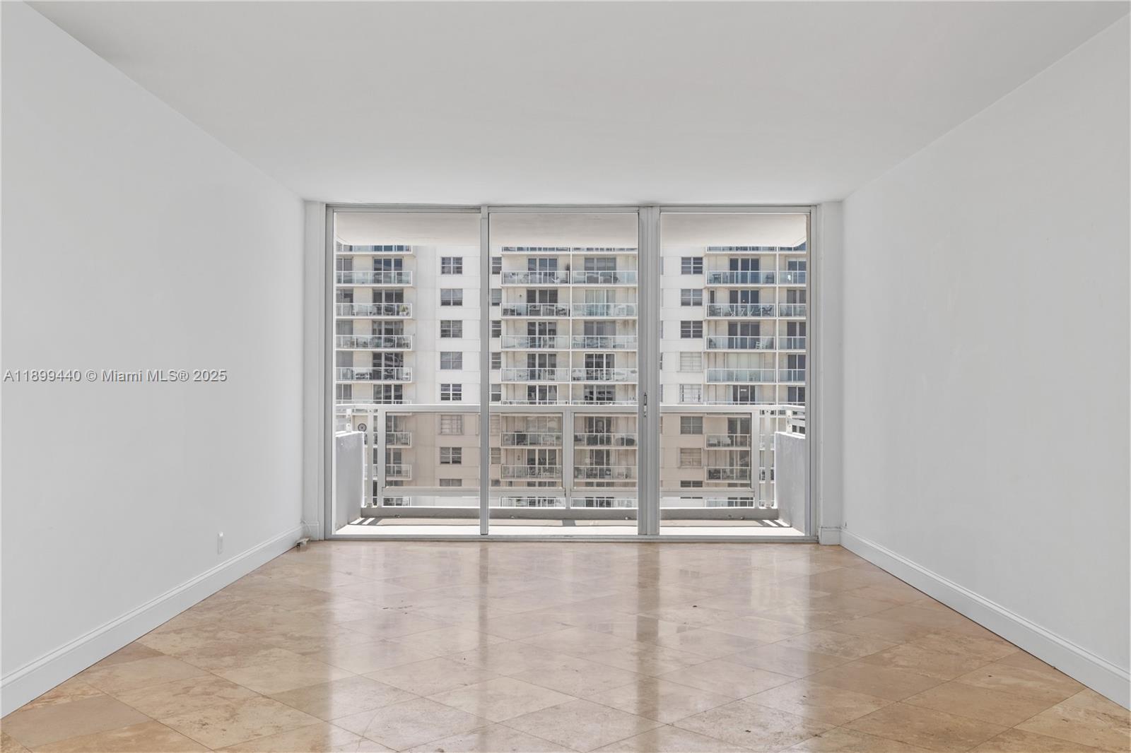 5700 Collins Avenue, Unit 10D Miami Beach, FL 33140 - Photo 1 of 47 an empty room with windows