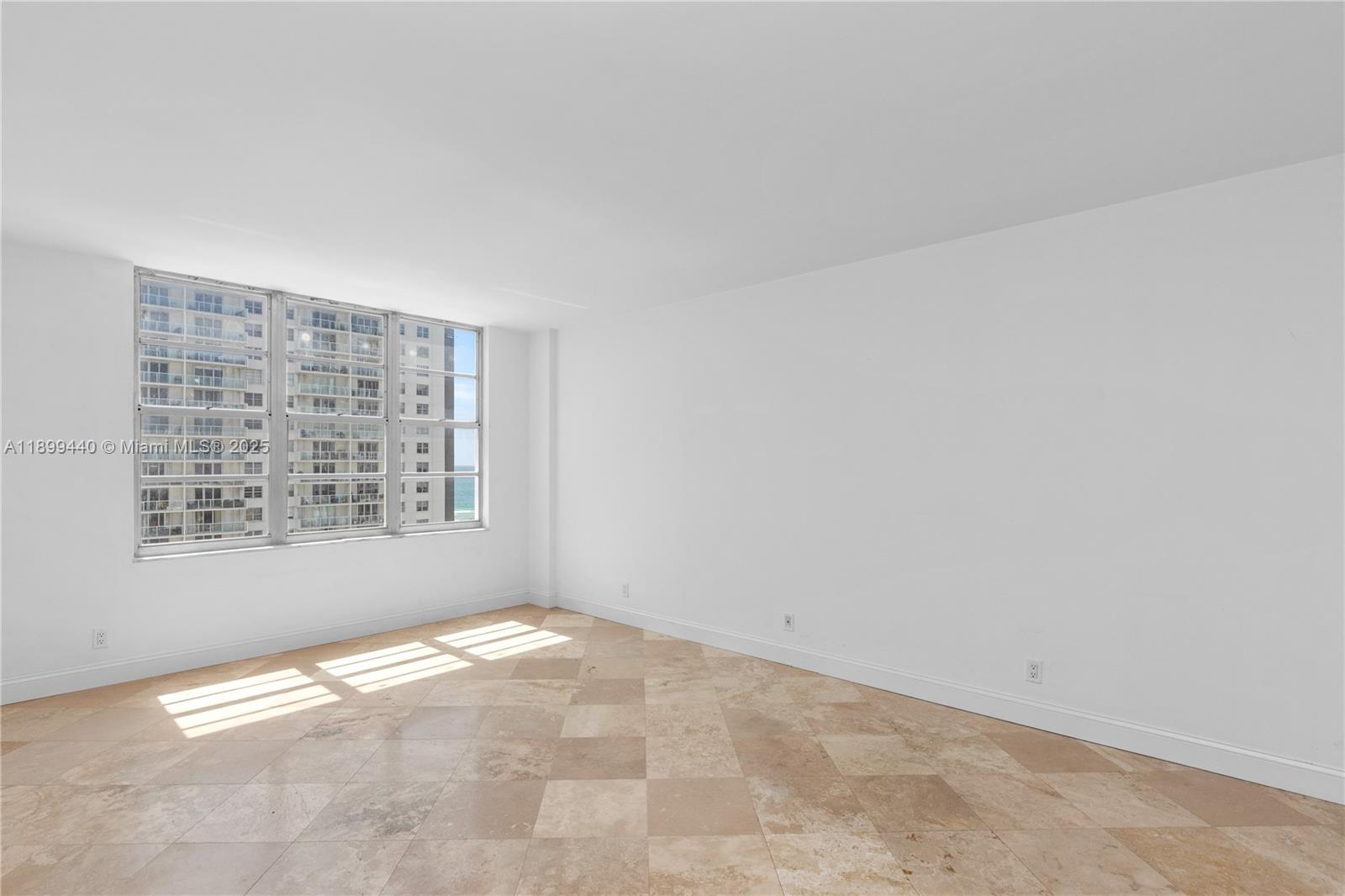 5700 Collins Avenue, Unit 10D Miami Beach, FL 33140 - Photo 17 of 47 an empty room with windows