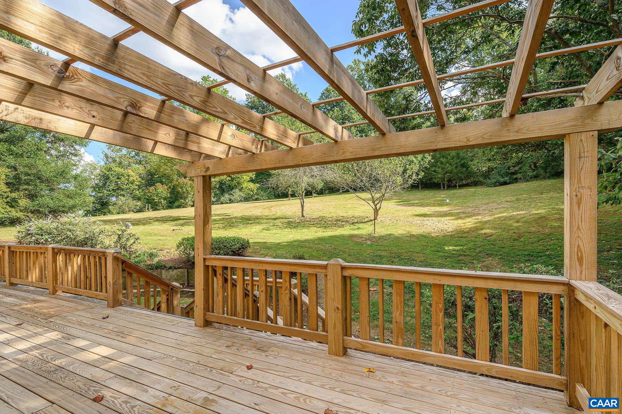 965 Nether Springs Road Afton, VA 22920 - Photo 29 of 38 a view of a wooden deck next to a yard