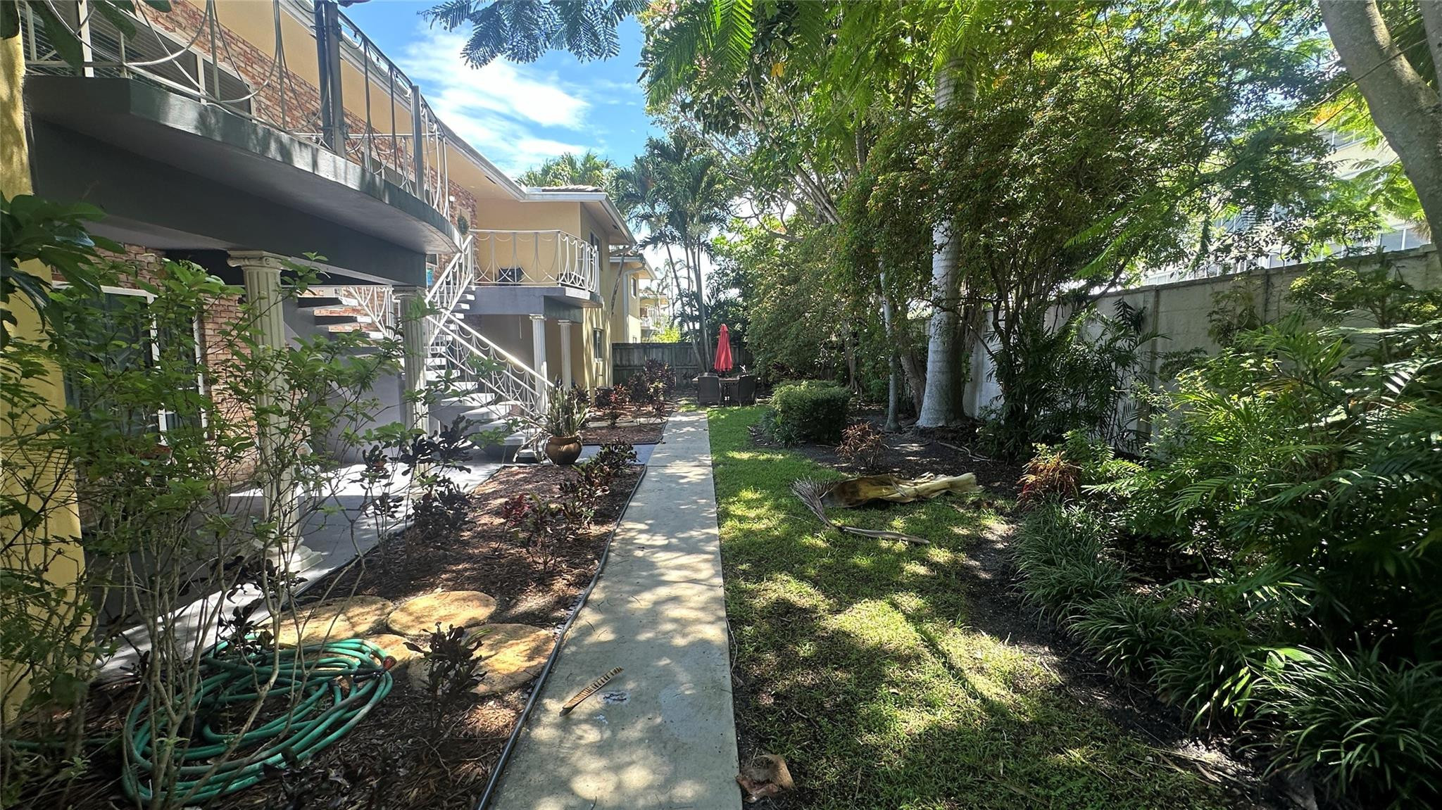 1900 Northeast 29th Street, Unit 2C Lighthouse Point, FL 33064 - Photo 20 of 21 a backyard of a house with lots of green space