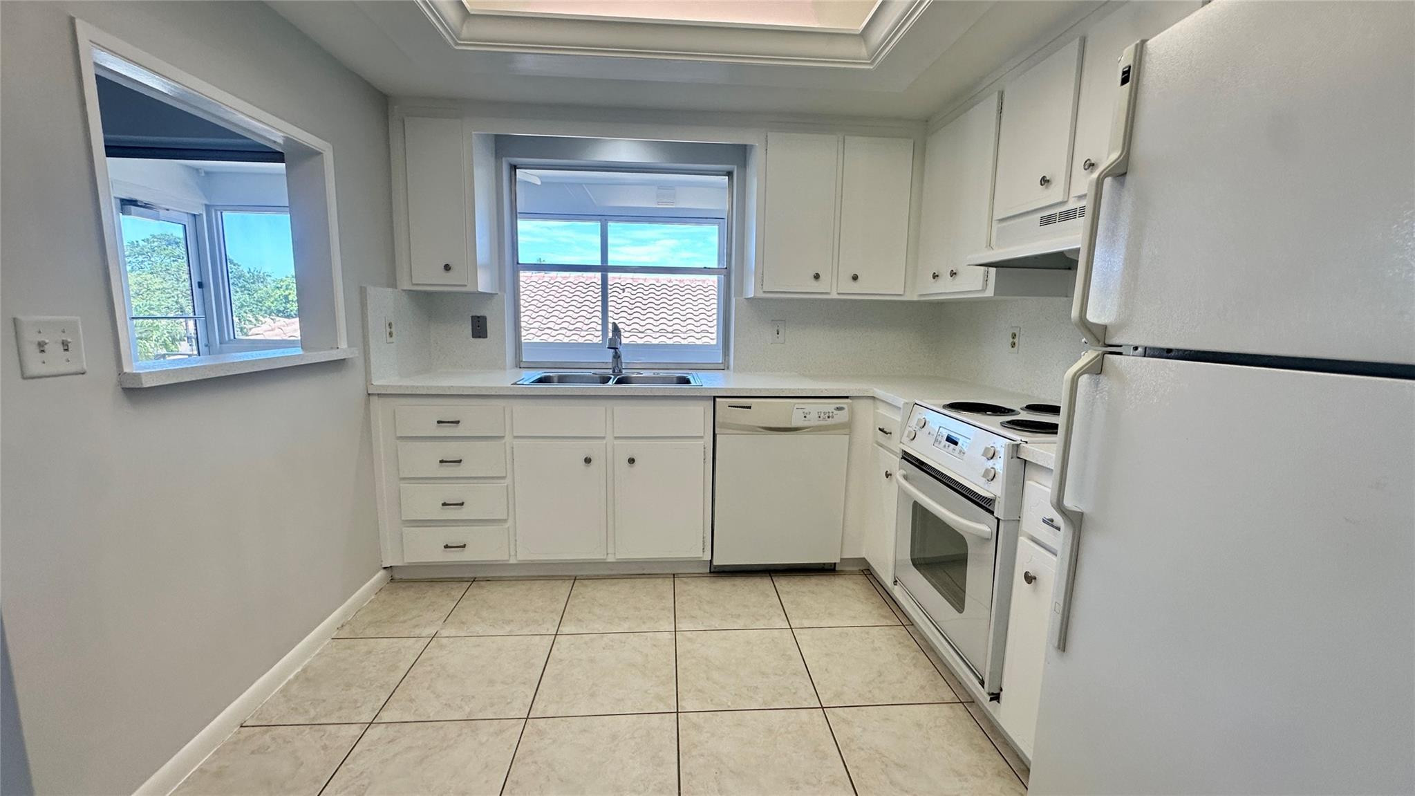 1900 Northeast 29th Street, Unit 2C Lighthouse Point, FL 33064 - Photo 3 of 21 a kitchen with stainless steel appliances a stove a refrigerator and a sink