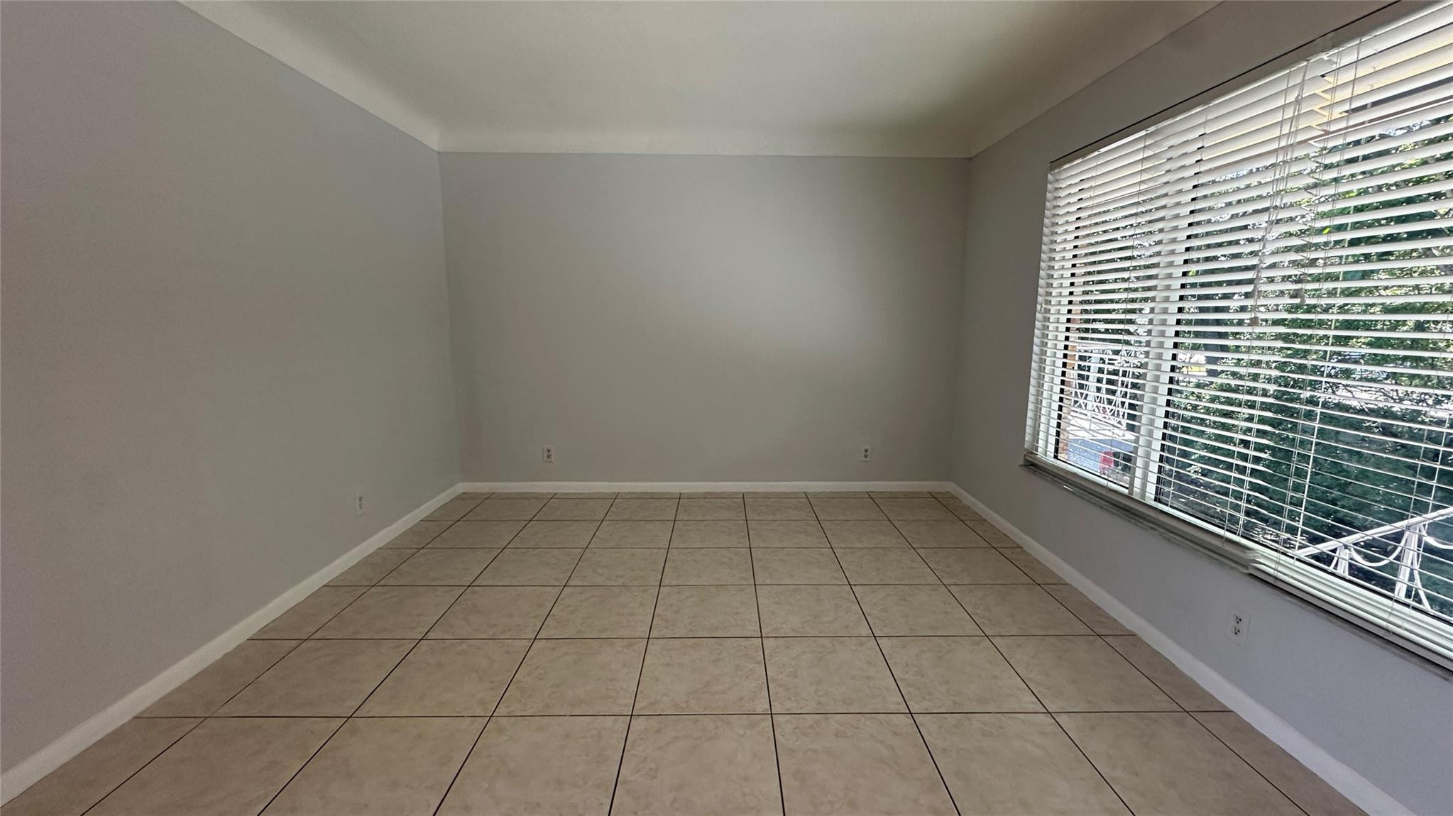 1900 Northeast 29th Street, Unit 2C Lighthouse Point, FL 33064 - Photo 5 of 21 a view of an empty room and window