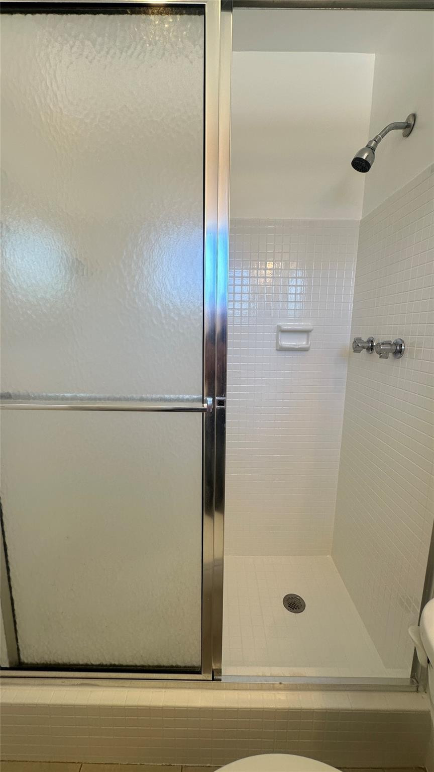 1900 Northeast 29th Street, Unit 2C Lighthouse Point, FL 33064 - Photo 10 of 21 a bathroom with a glass shower door