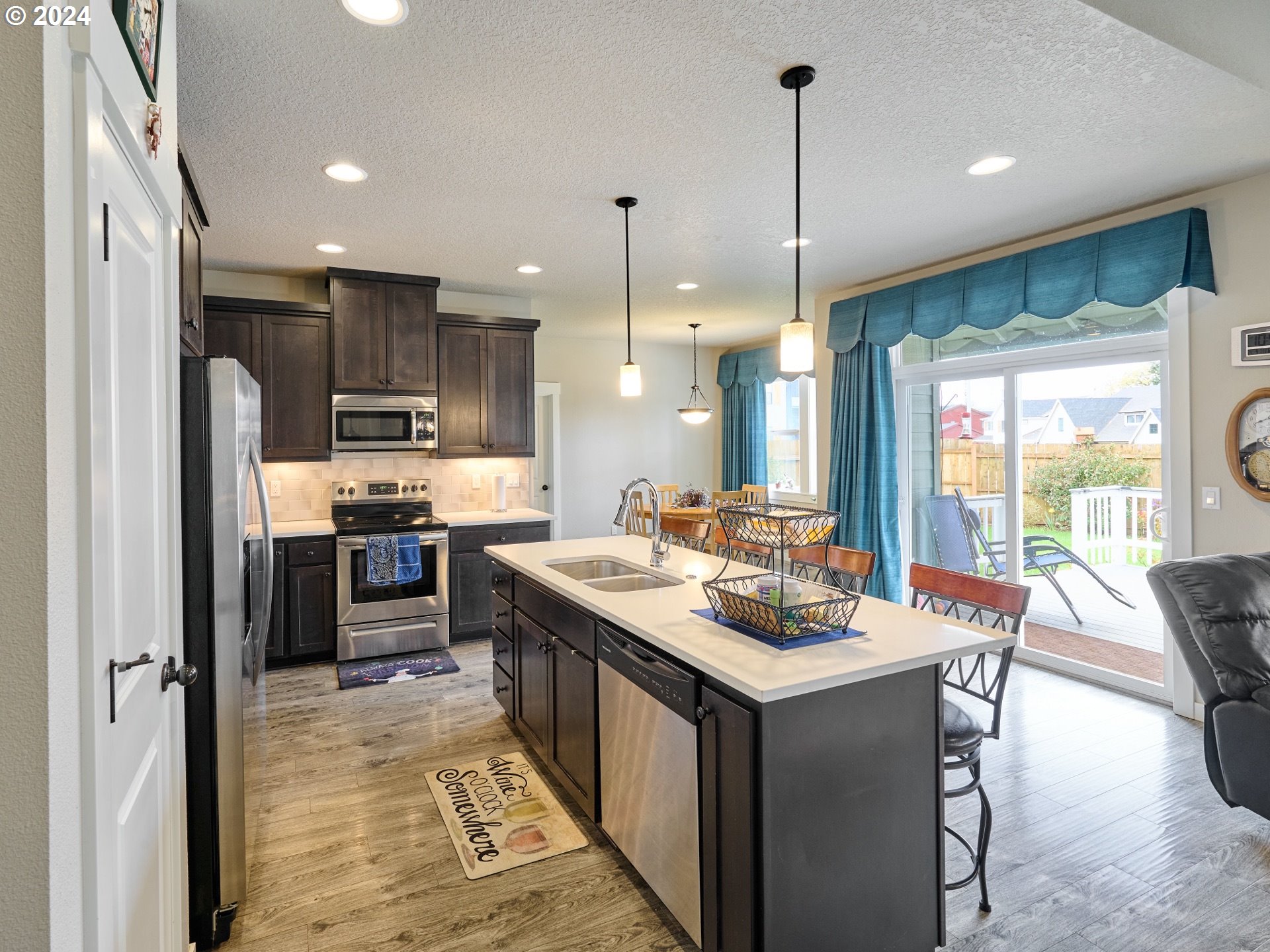 860 Southeast Darrow Road Estacada, OR 97023 - Photo 6 of 6 a kitchen with kitchen island a large counter top space appliances and a center island