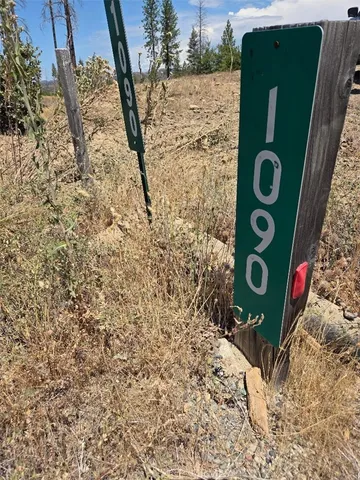 a view of a dirt road with a building in the background