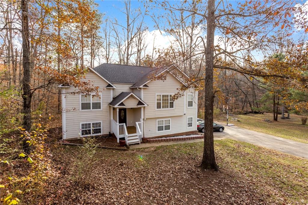 a view of a house with a yard covered in snow