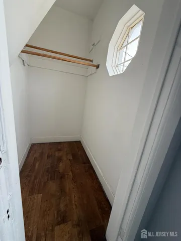 a view of a room with rack on the wall and a window