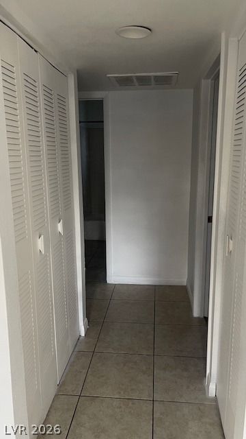 350 East Desert Inn Road, Unit B103 Las Vegas, NV 89109 - Photo 11 of 22 A well-maintained hallway with neutral tile flooring, ready for your personal touch.