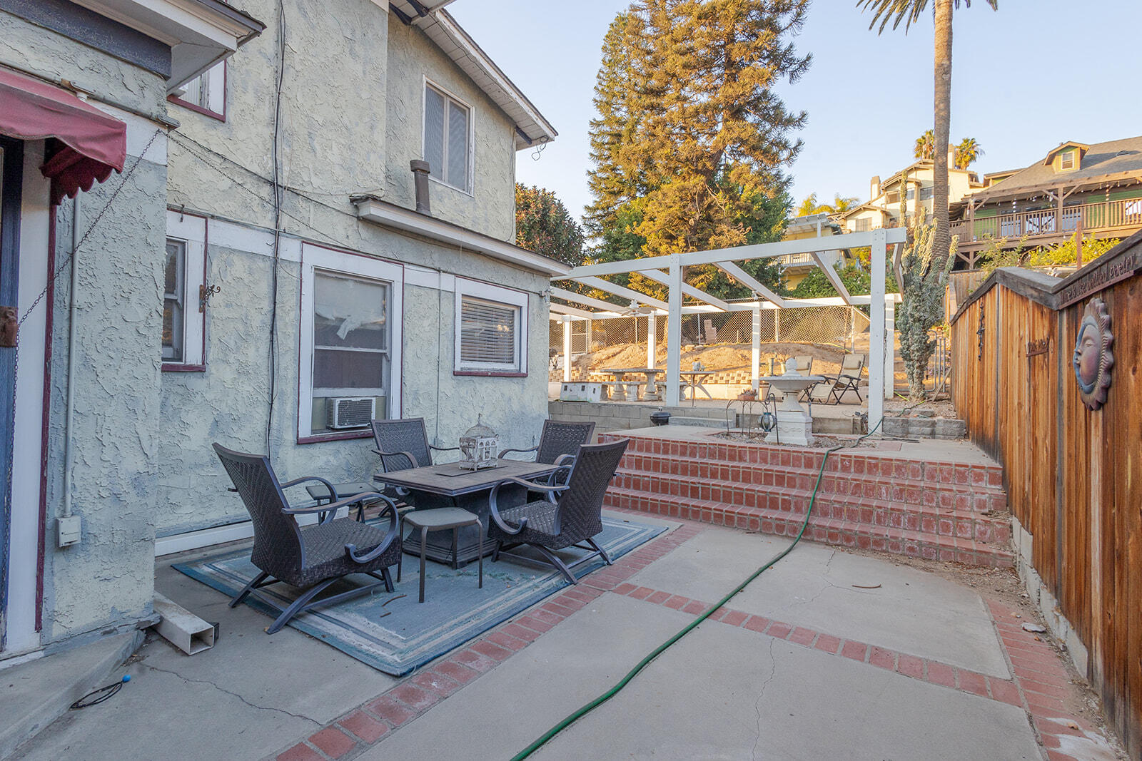 13429 Bailey Street Whittier, CA 90601 - Photo 45 of 54 a view of a patio with table and chairs with wooden floor and fence
