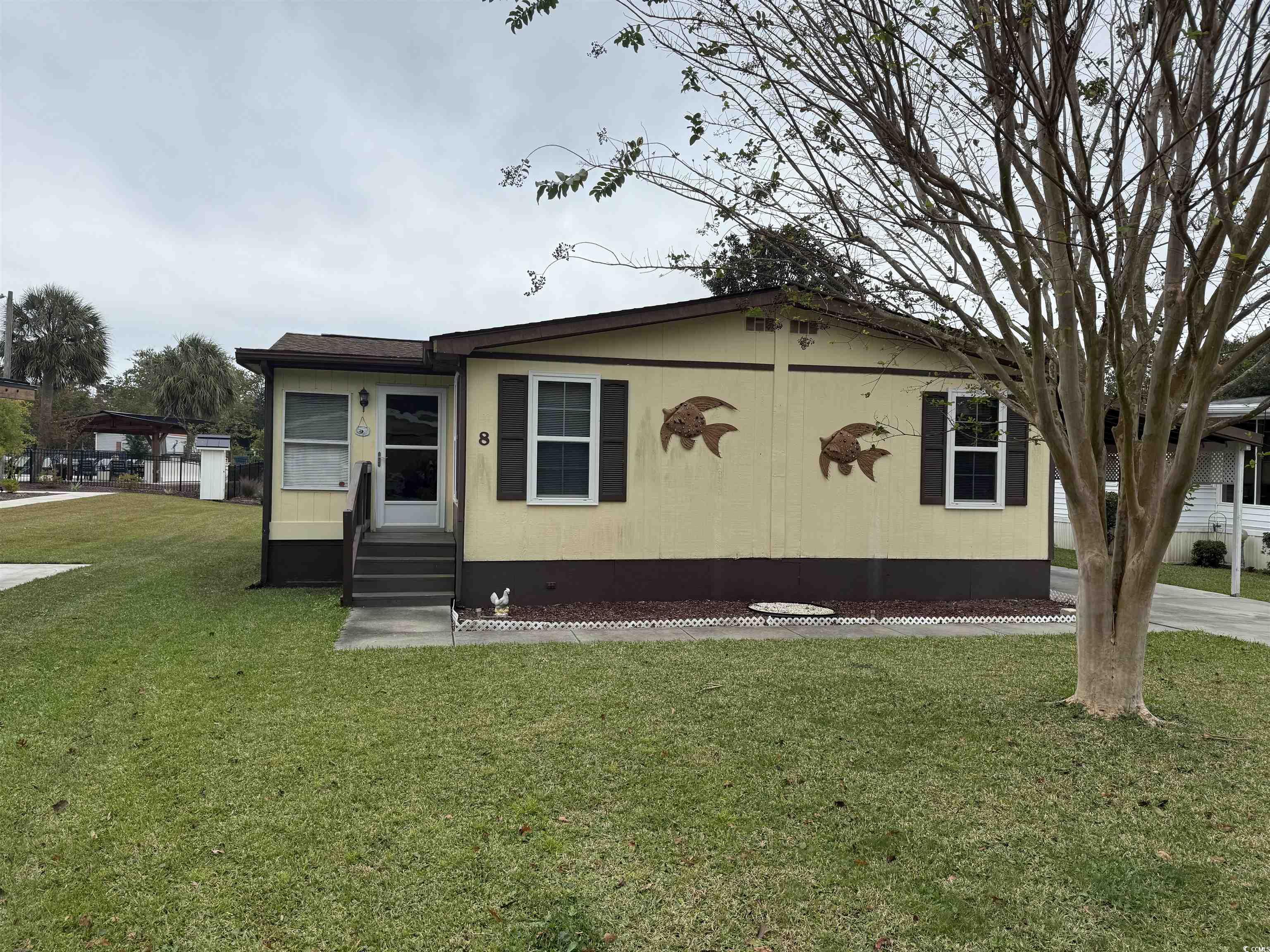 8 Buccaneer Street Murrells Inlet, SC 29576 - Photo 2 of 28 Manufactured / mobile home with entry steps and a front yard