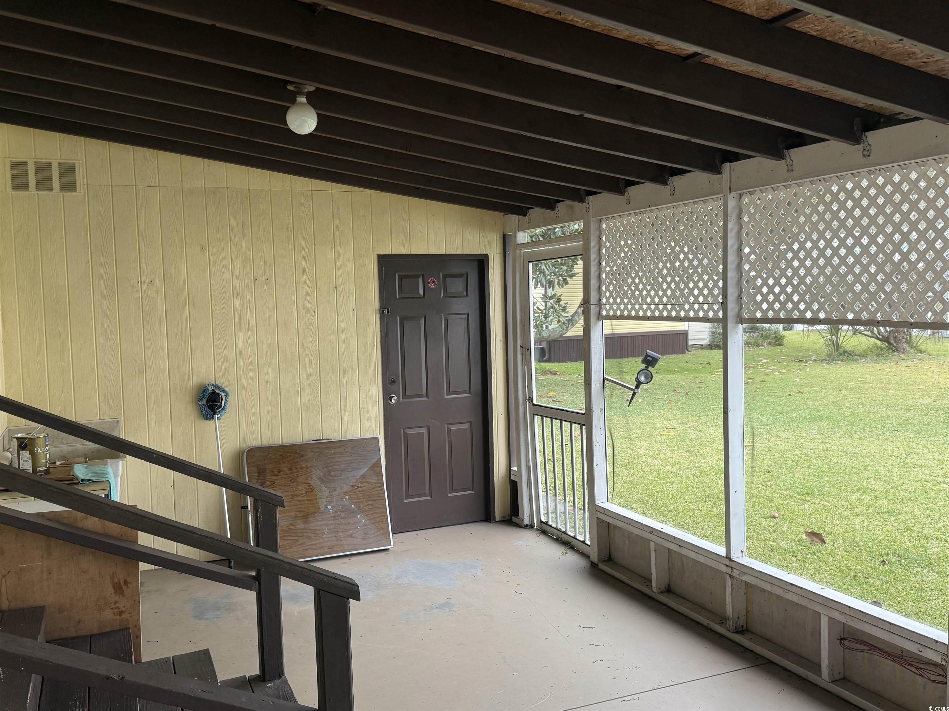 8 Buccaneer Street Murrells Inlet, SC 29576 - Photo 5 of 28 View of Screened in patio leading to workshop.
