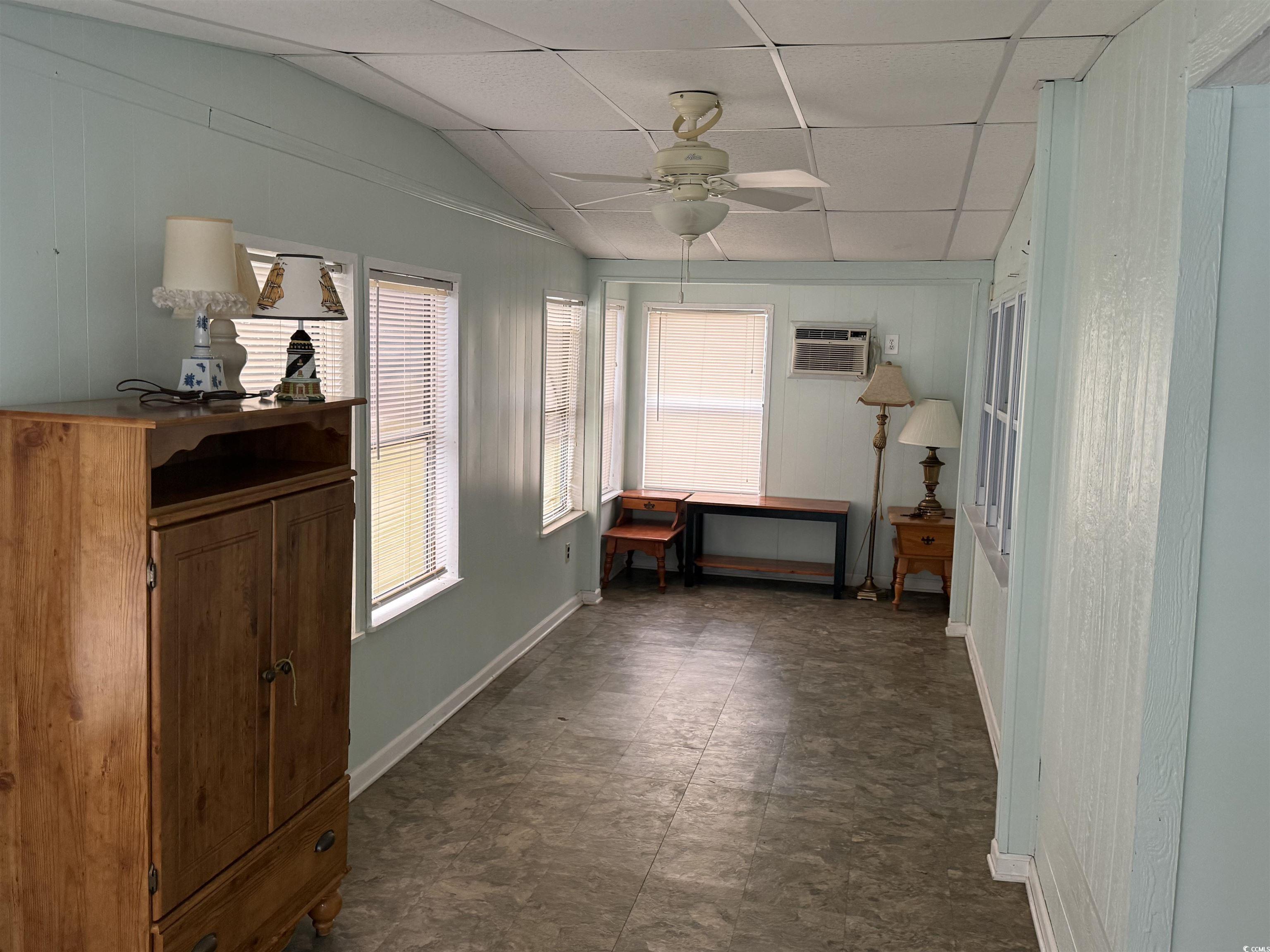 8 Buccaneer Street Murrells Inlet, SC 29576 - Photo 6 of 28 Corridor with a drop ceiling, an office area, a wall mounted air conditioner, lofted ceiling, and wooden walls