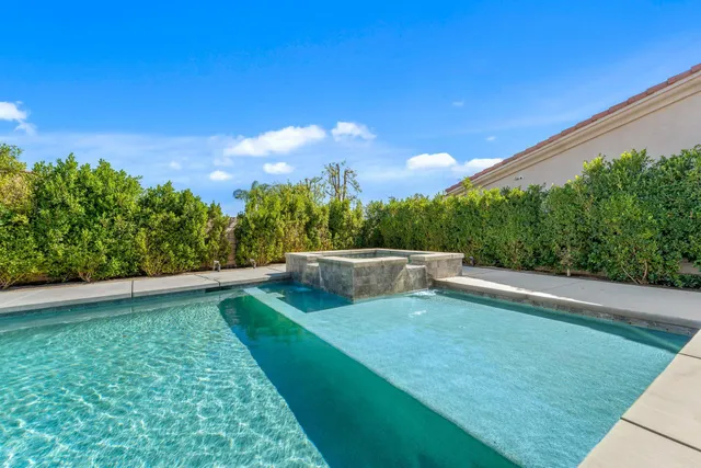 a view of a patio with swimming pool table and chairs