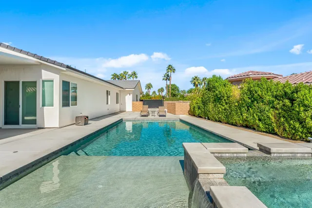 a view of roof with potted plants in front of door