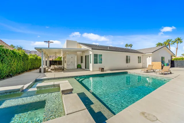 a living room with furniture and a mirror