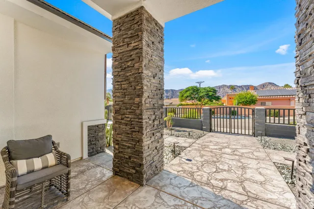 a kitchen with stainless steel appliances granite countertop a stove a sink a refrigerator and chairs