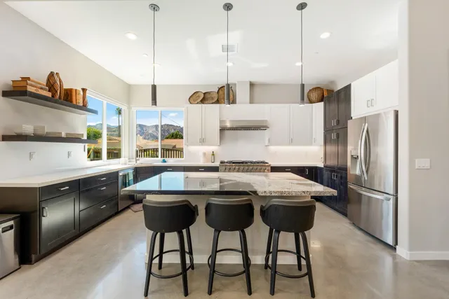 a kitchen with stainless steel appliances granite countertop a stove oven and refrigerator