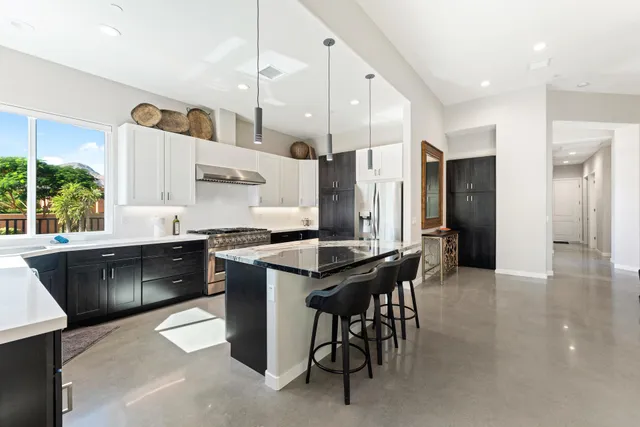 a kitchen with a dining table cabinets and appliances
