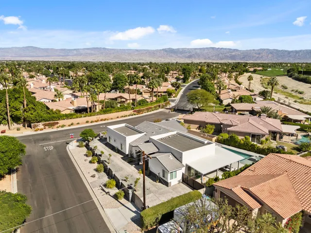 an aerial view of residential houses with outdoor space