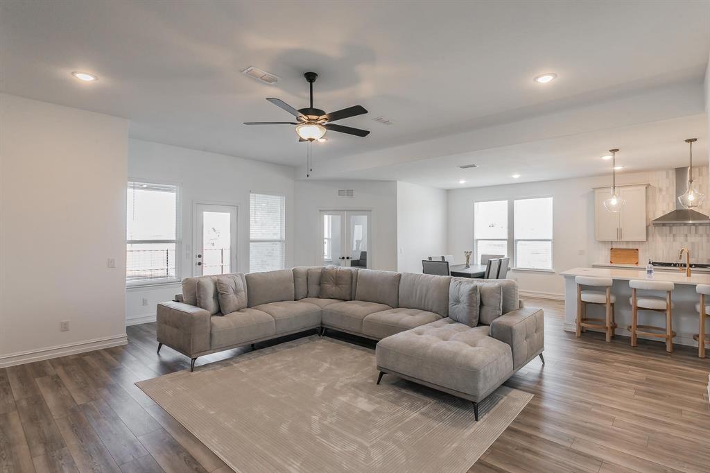 4305 Noble Lane Midlothian, TX 76065 - Photo 13 of 40 a living room with furniture ceiling fan and a wooden floor
