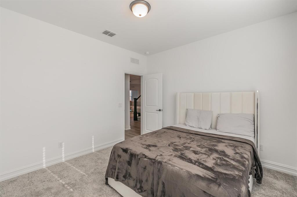 4305 Noble Lane Midlothian, TX 76065 - Photo 21 of 40 a bedroom with a bed and a lamp