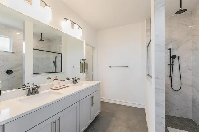 a bathroom with a double vanity sink mirror and double