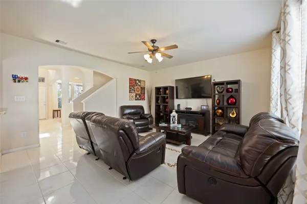 a living room with furniture a flat screen tv and a fireplace