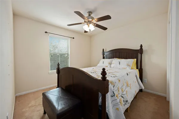 a bed sitting in a bedroom next to a window