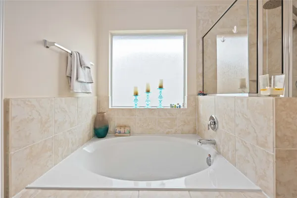 a bathroom with a bathtub and shower