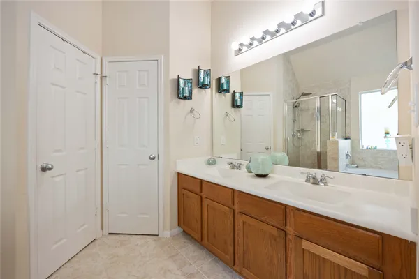 a spacious bathroom with double vanity sink and a mirror