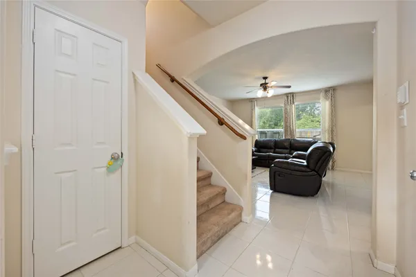 a living room with furniture and a ceiling fan