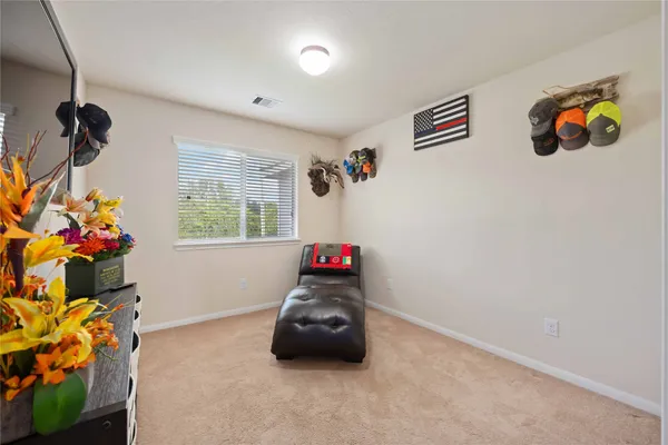 a bedroom with a bed and a painting on the wall