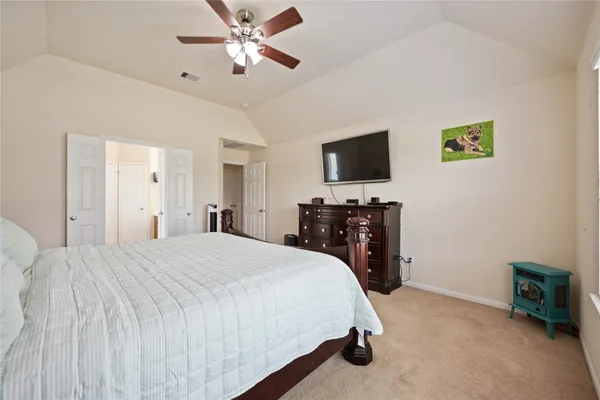 a bedroom with a bed and a flat screen tv